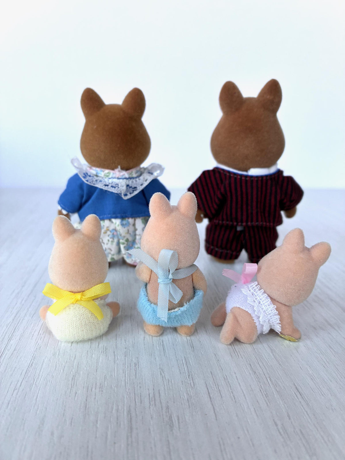 Sylvanian Families Calico Critters Wild Boar Family (Flair, boxed): back view of all five figures showing clothing and ribbon ties