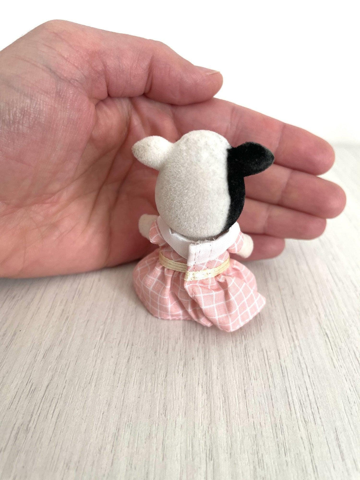 Back view of the cow girl showing the black patch across her back — Calico Critters and Sylvanian Families