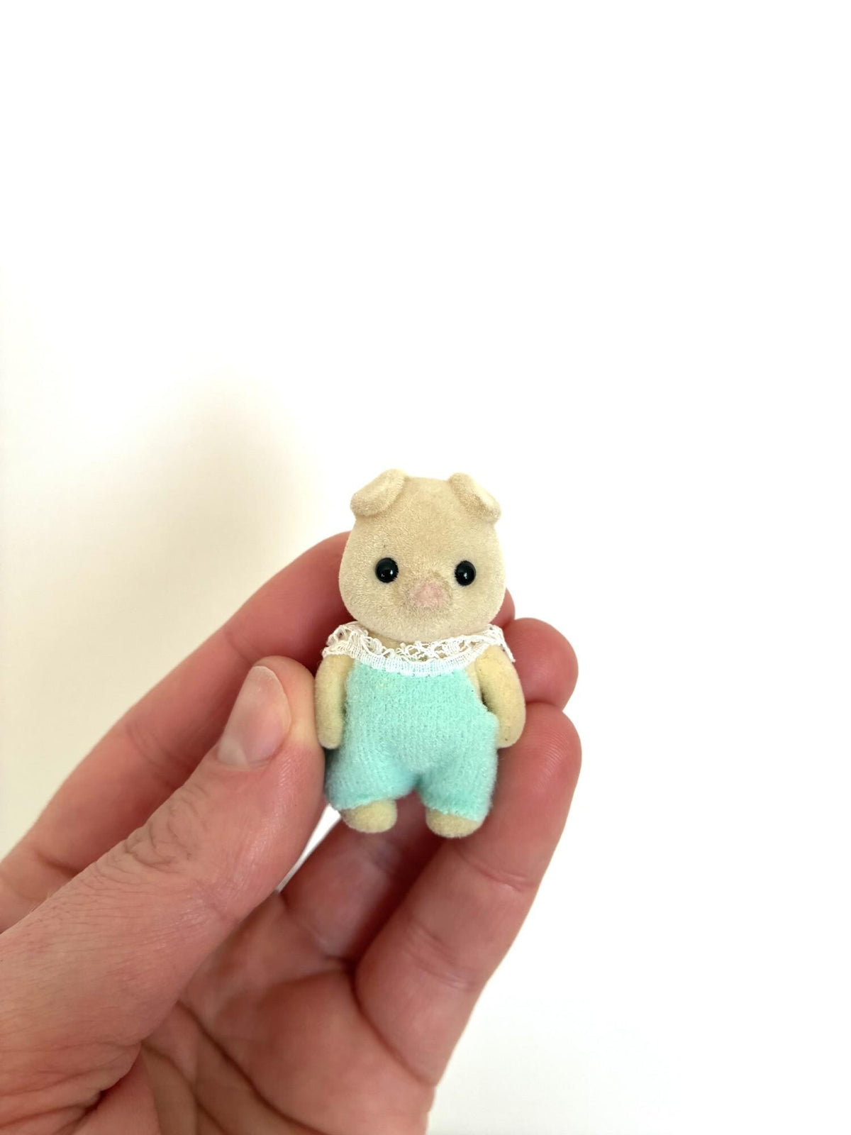Calico Critters Sylvanian Families pig baby figure front view showing pink snout