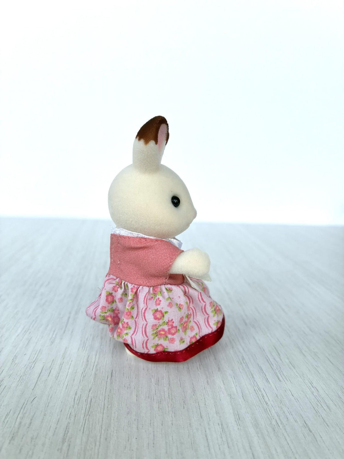 Calico Critters Sylvanian Families Hopscotch Chocolate rabbit mother in pink floral dress with bow, side view