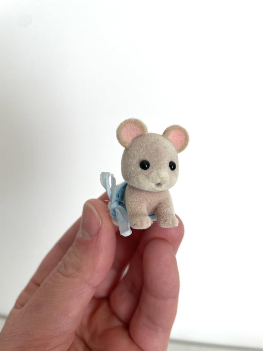 Maces Mouse baby boy in blue romper held in hand, front view — Calico Critters and Sylvanian Families