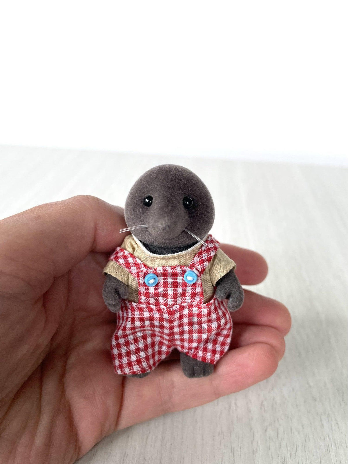Mole dad held in hand for scale showing blue buttons on the overalls — Calico Critters and Sylvanian Families