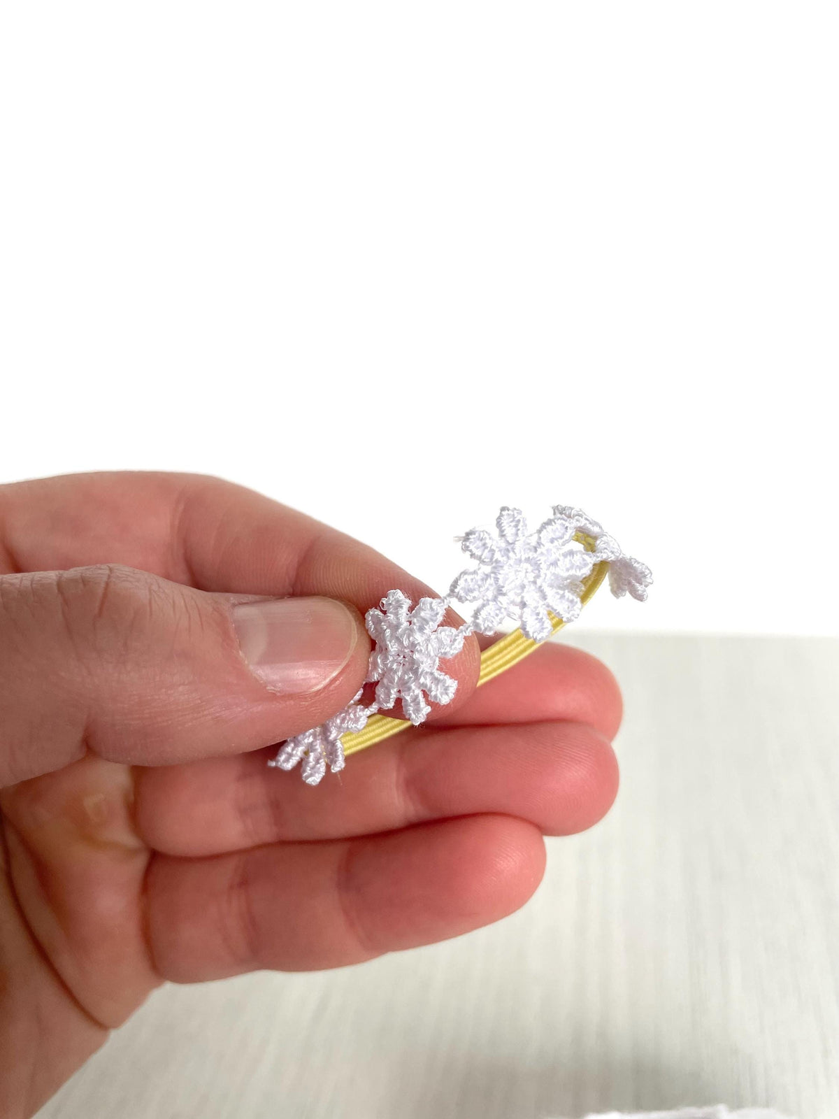 Close-up of white daisy flower crown on yellow band for Calico Critters and Sylvanian Families