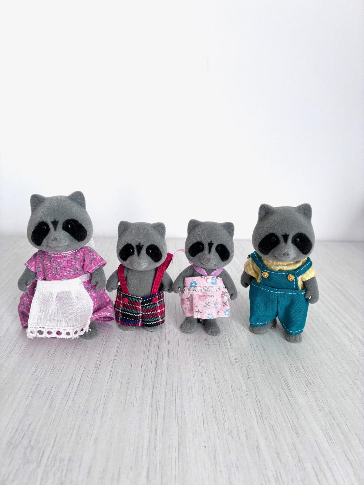 Calico Critters Sylvanian Families vintage Chestnut Raccoon family of 4, full family group front view on wood floor