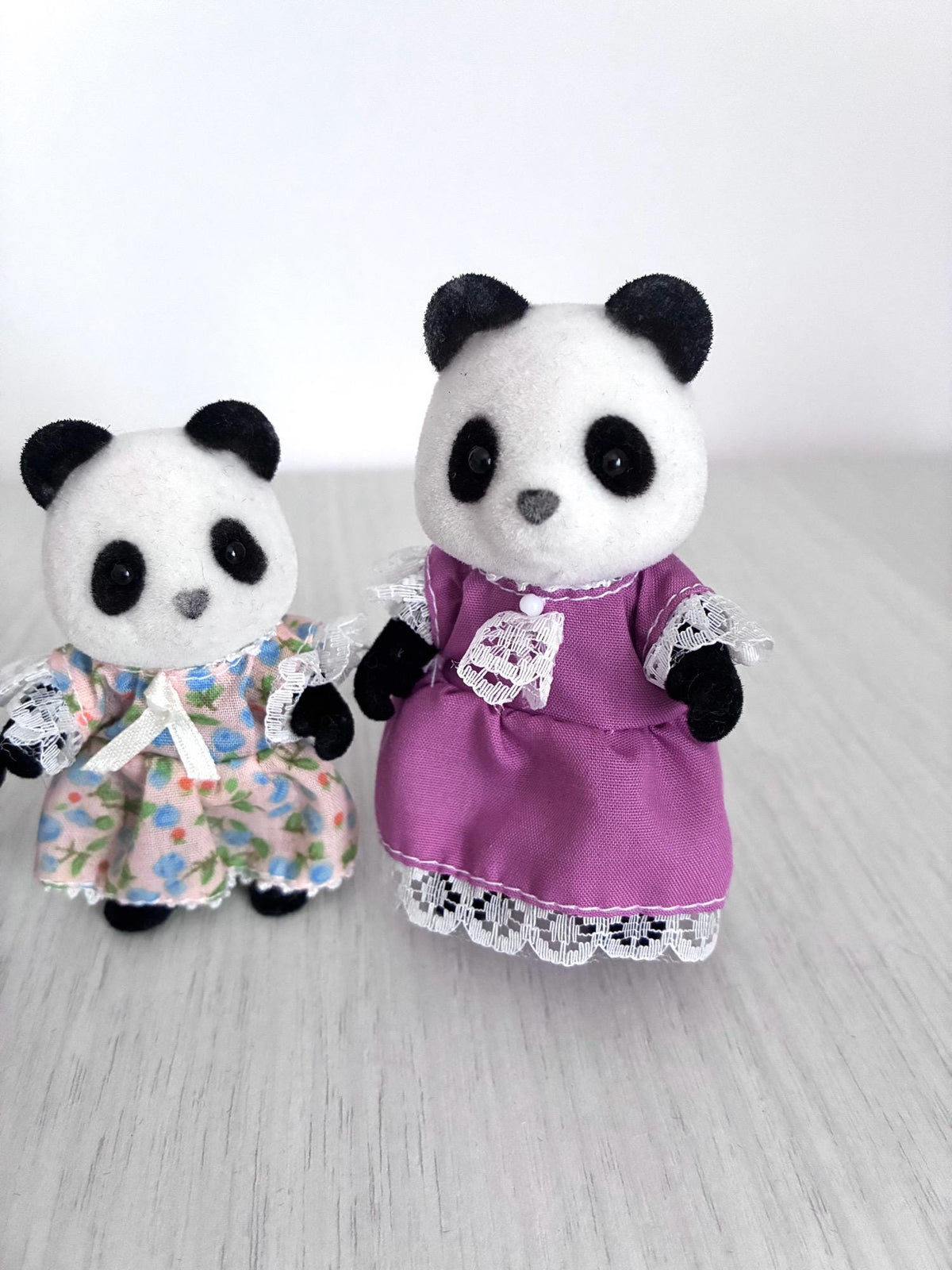 Calico Critters Sylvanian Families vintage Bamboo Panda family of 4, daughter in peach floral dress beside mother in lilac dress