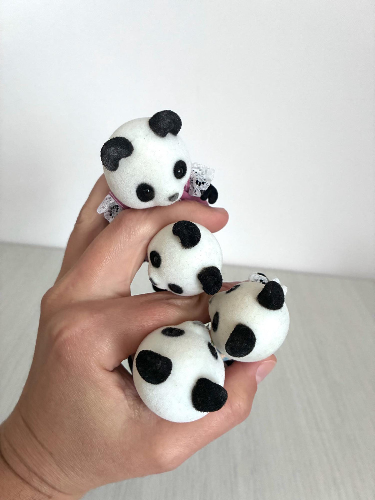 Calico Critters Sylvanian Families vintage Bamboo Panda family of 4, close up in hand of all four heads showing flocking