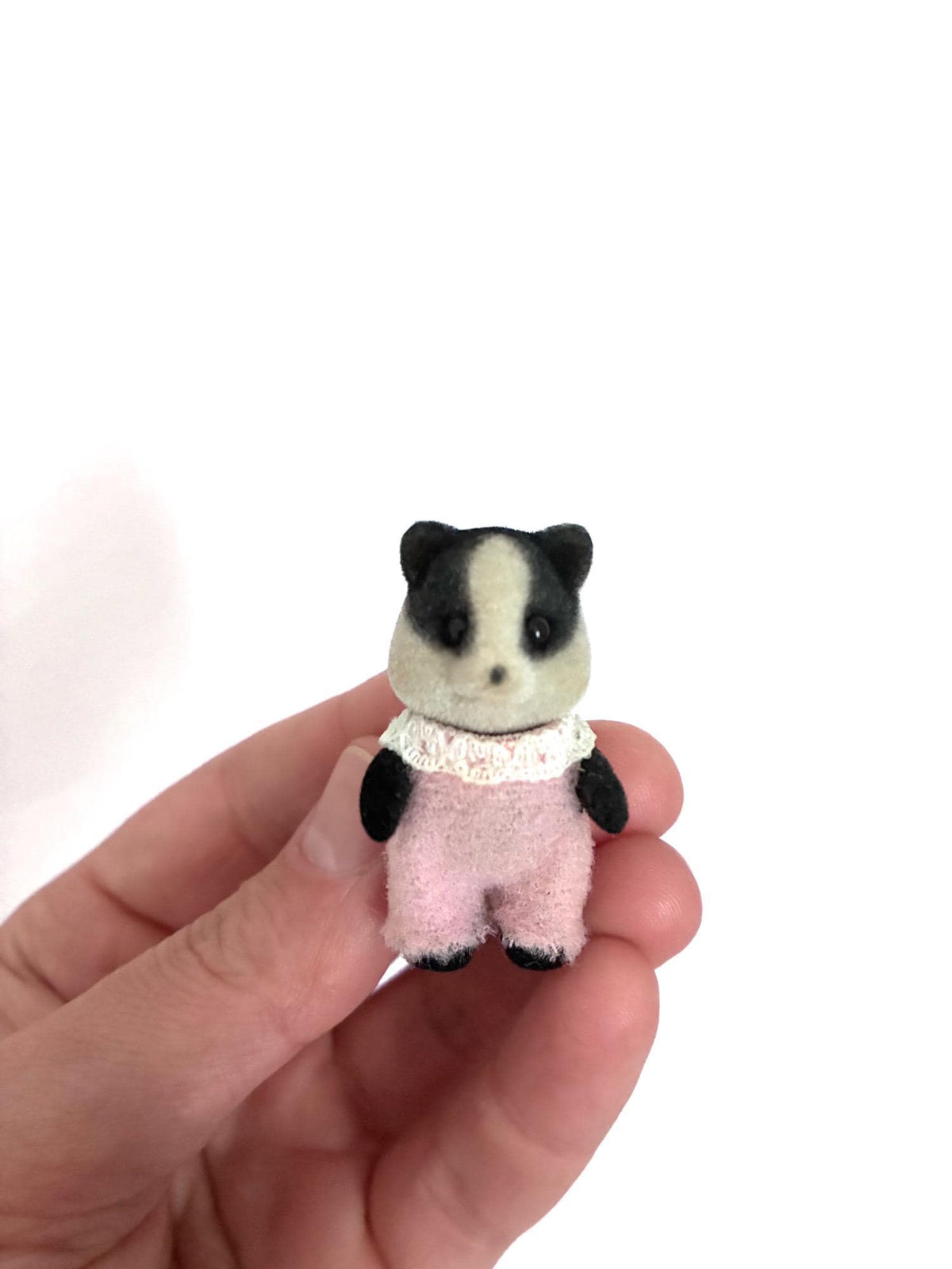 Calico Critters Sylvanian Families April Underwood badger baby, front view in hand