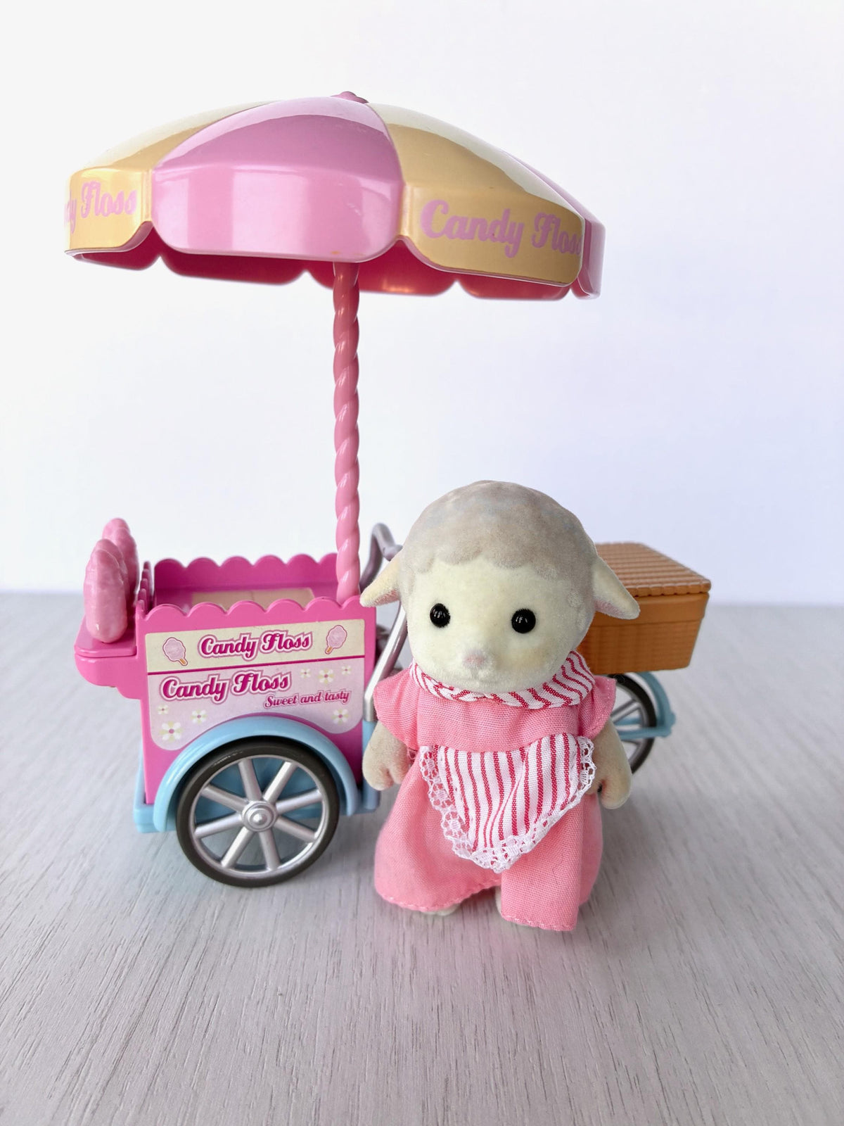Sylvanian Families Calico Critters Dolly's Candy Floss (Flair 4678) Dolly Dale sheep aunt standing beside her pink candy floss tricycle cart under the umbrella