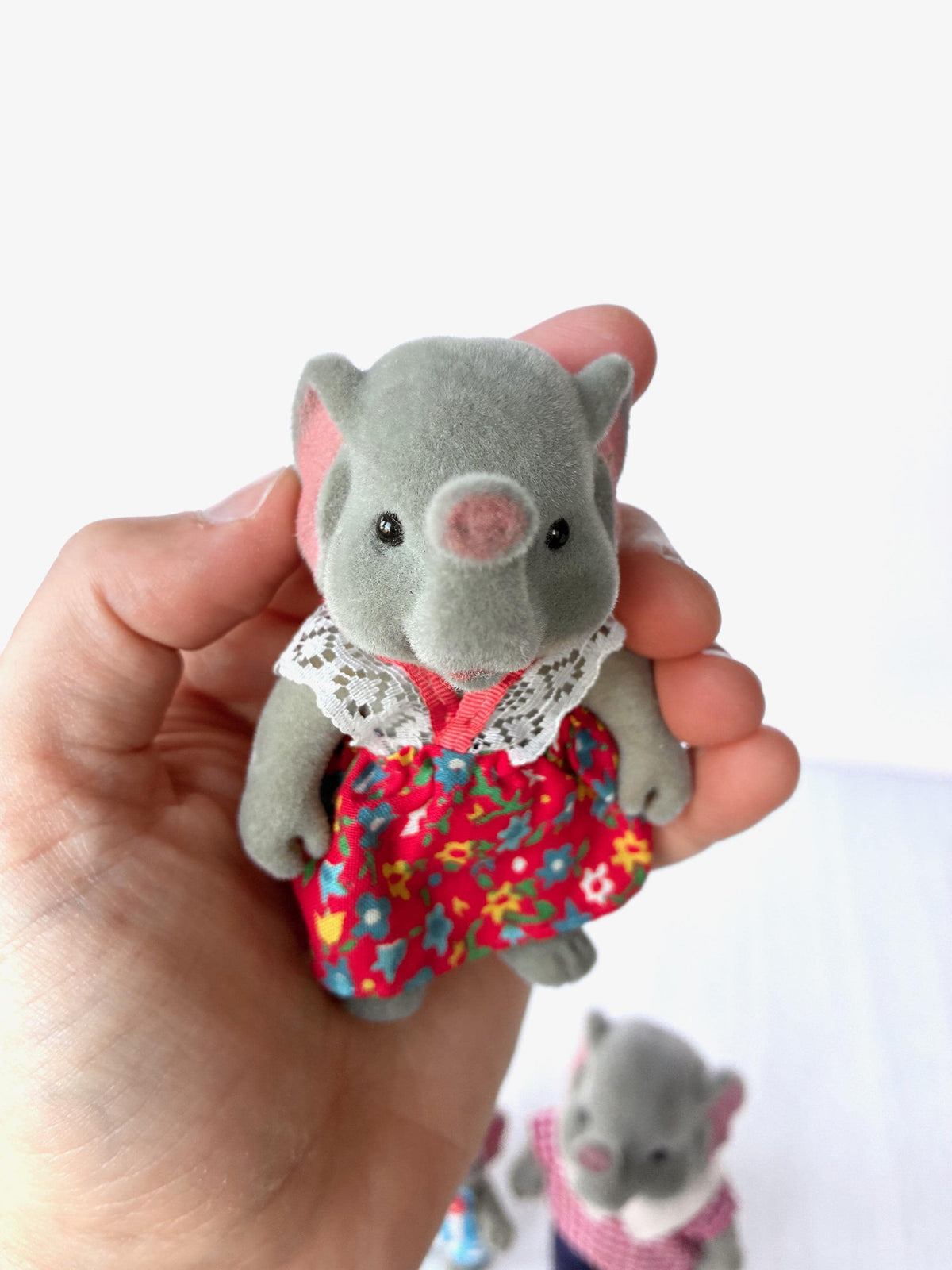 Bärenwald Forest Families elephant mother in red floral dress with lace collar, held in hand for scale