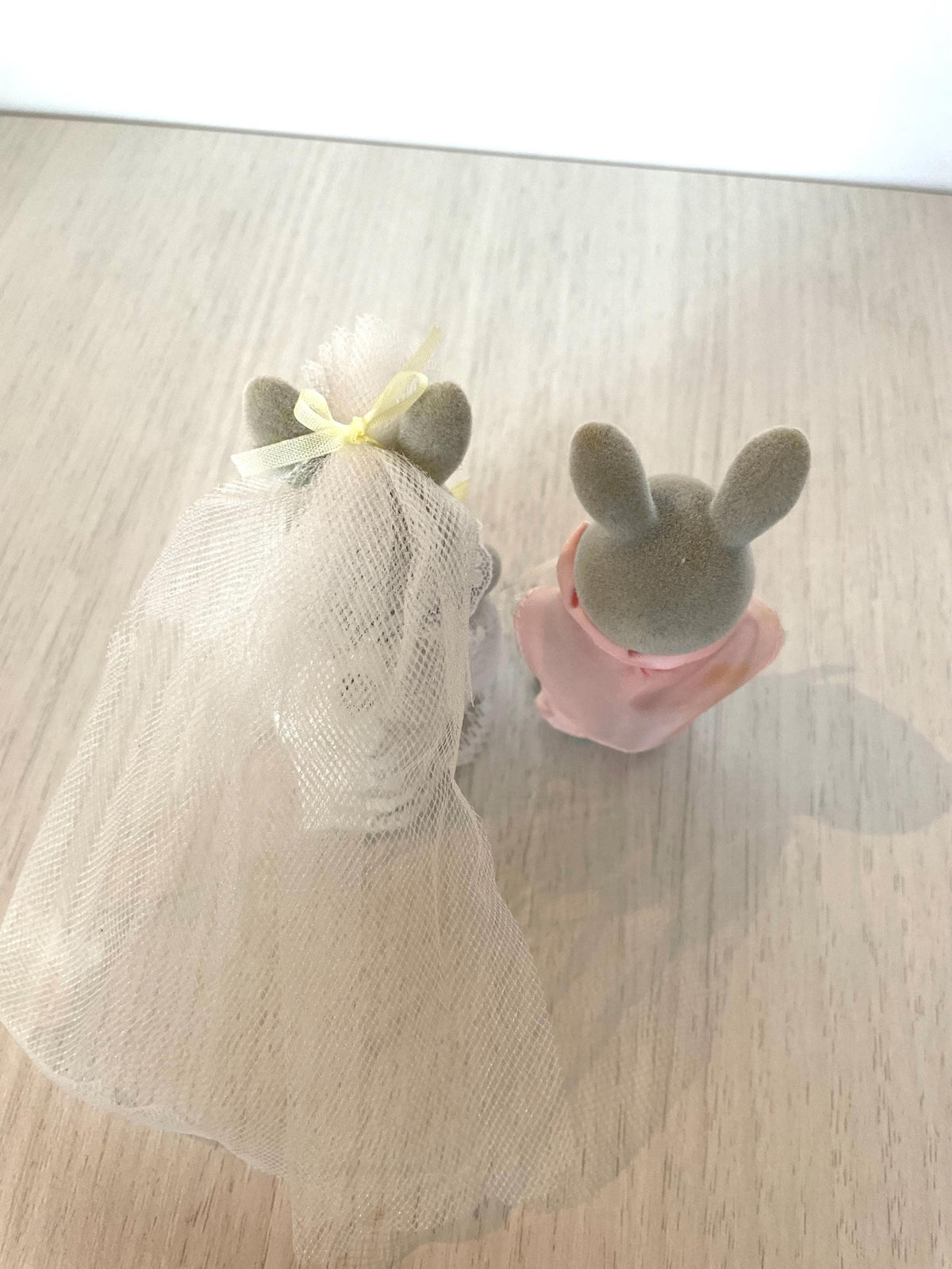 Overhead view of the grey rabbit bride and groom side by side showing veil and wedding suit detail — Calico Critters and Sylvanian Families