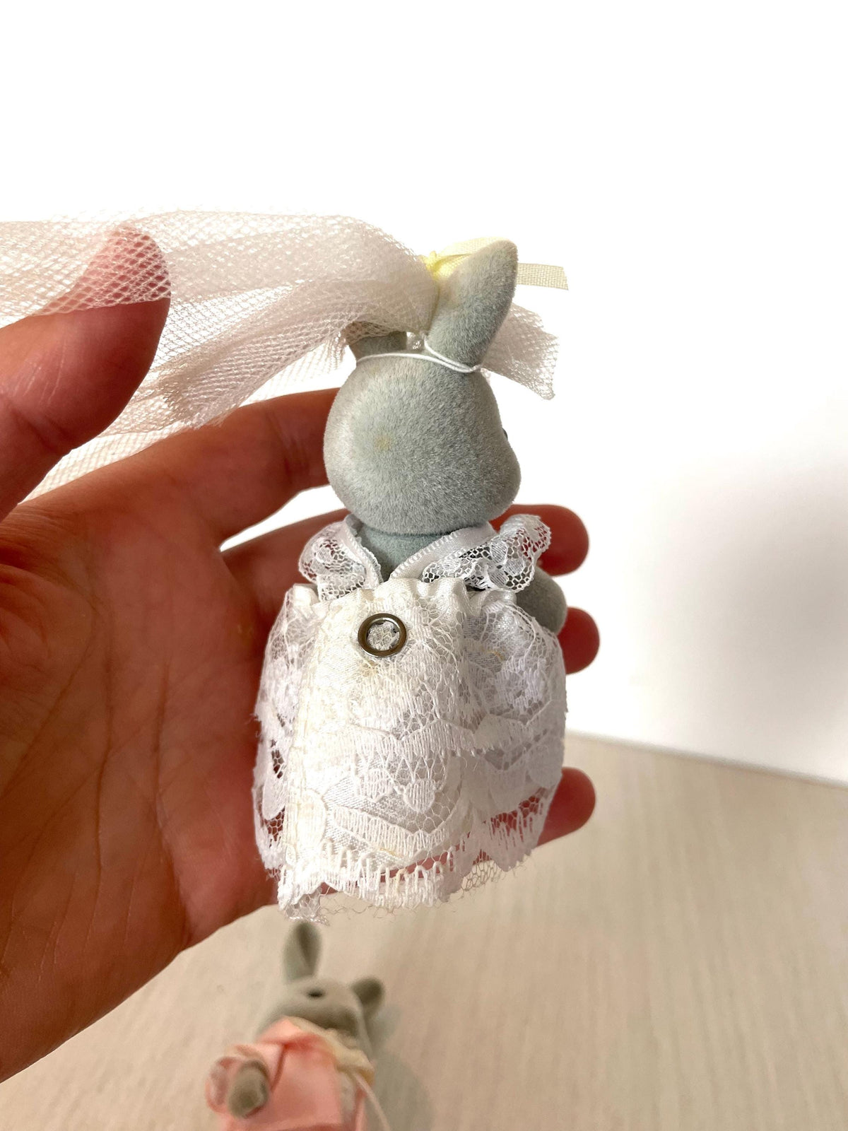 Close-up of the snap fastener on the back of the bride lace wedding gown held in hand for scale — Calico Critters and Sylvanian Families