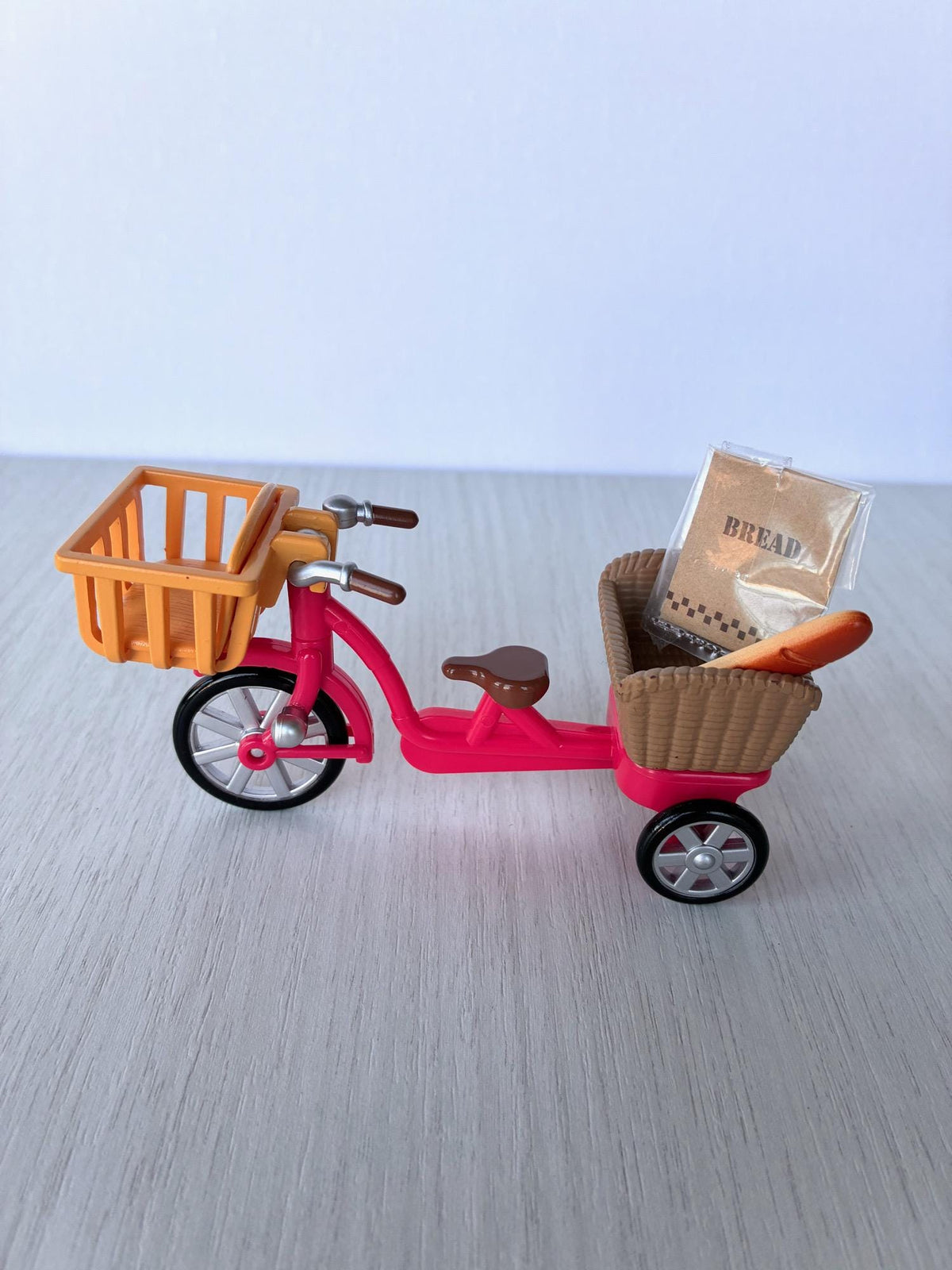 Sylvanian Families Calico Critters red bicycle with orange front basket, rear basket, child seat, baguette and bread bag – photo 5 of 8