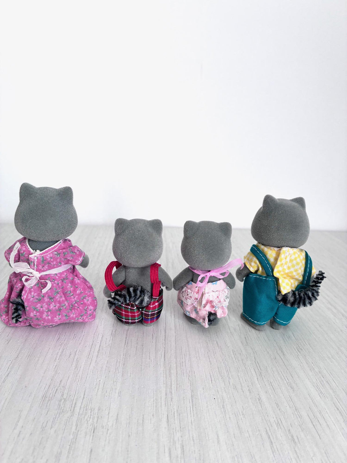 Calico Critters Sylvanian Families vintage Chestnut Raccoon family of 4, back view showing flocking and fabric ringed tails on all four