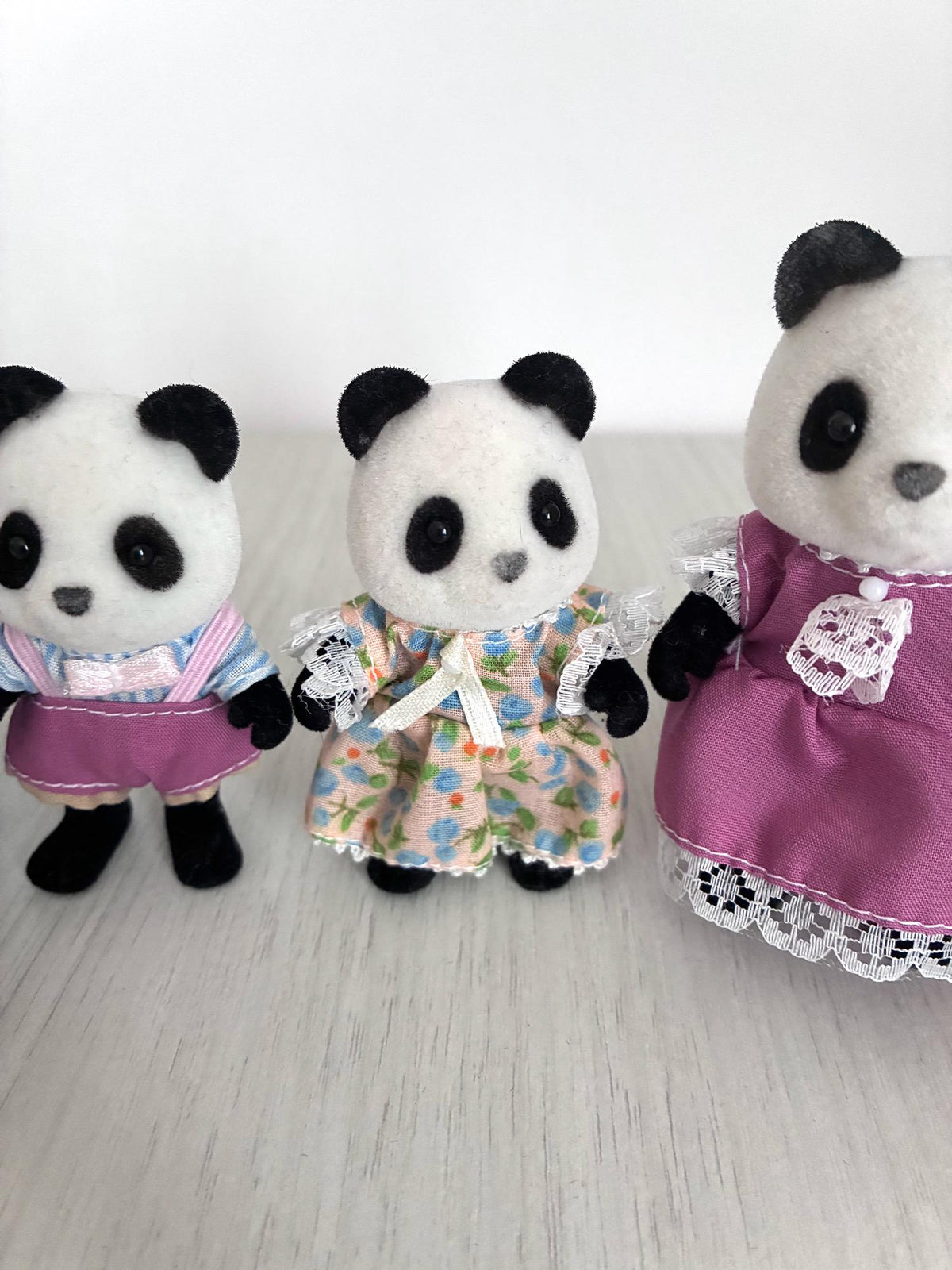 Calico Critters Sylvanian Families vintage Bamboo Panda family of 4, son in blue striped shirt beside daughter in peach floral dress