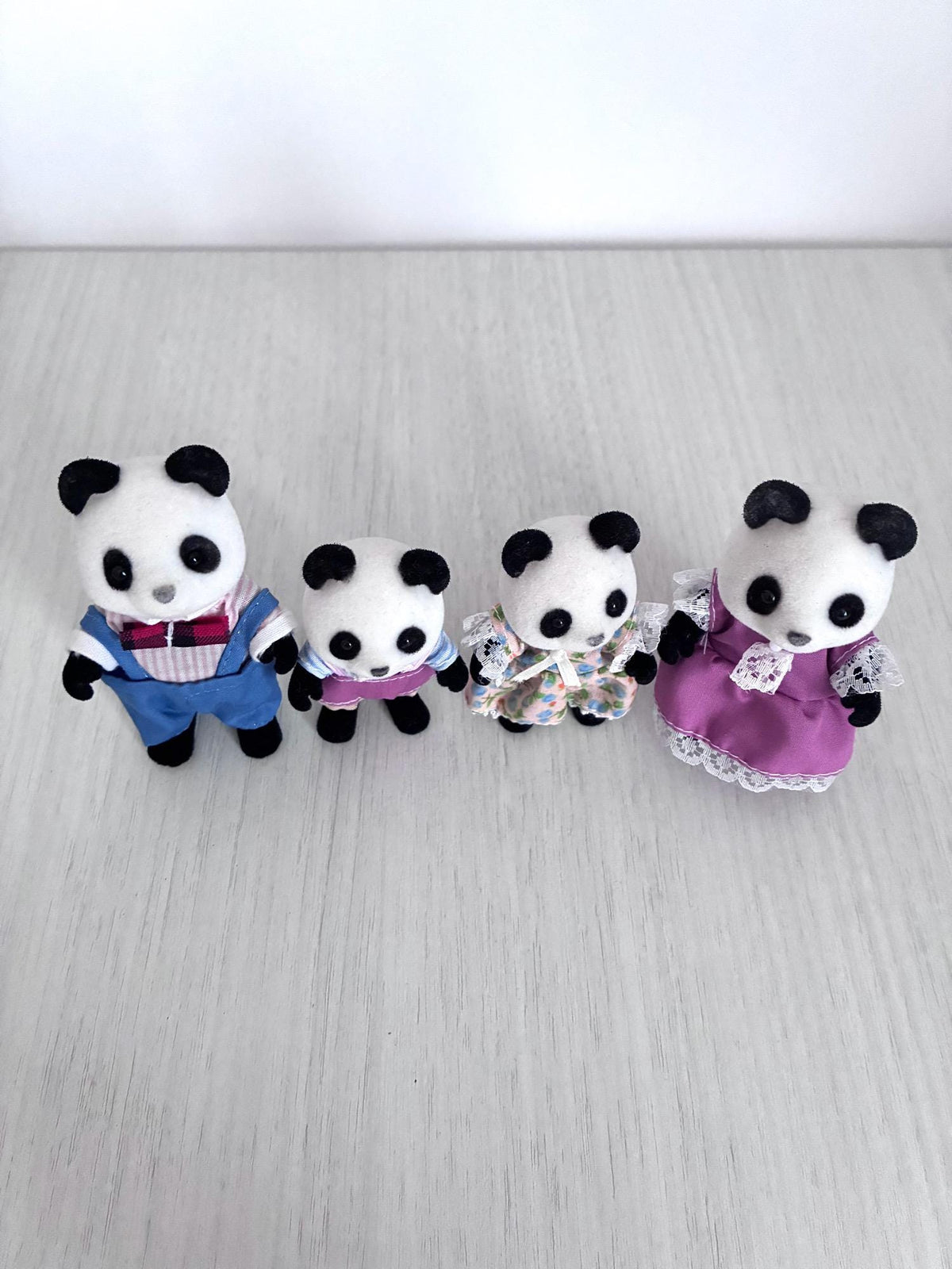 Calico Critters Sylvanian Families vintage Bamboo Panda family of 4, full family front view close up on wood floor