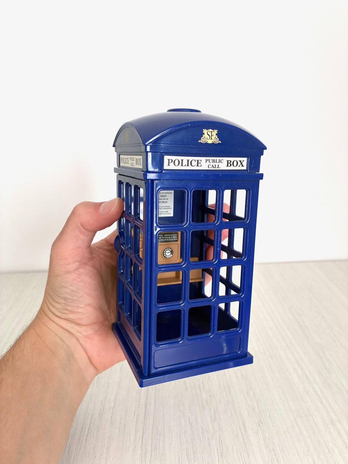 Hand holding Sylvanian Families blue Police Call Box for scale, Calico Critters vintage Flair accessory