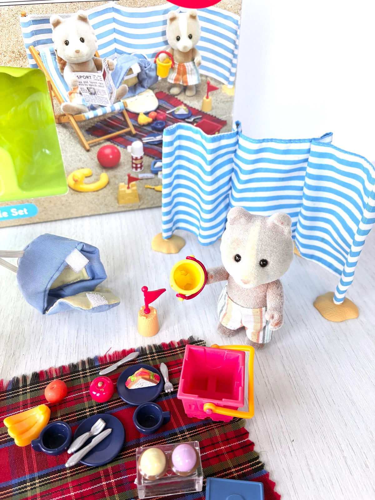 Sylvanian Families Calico Critters Day at the Seaside Set (Flair 4870): Vespa Farthing holding the yellow bucket in front of the windbreak, picnic rug and Flair box