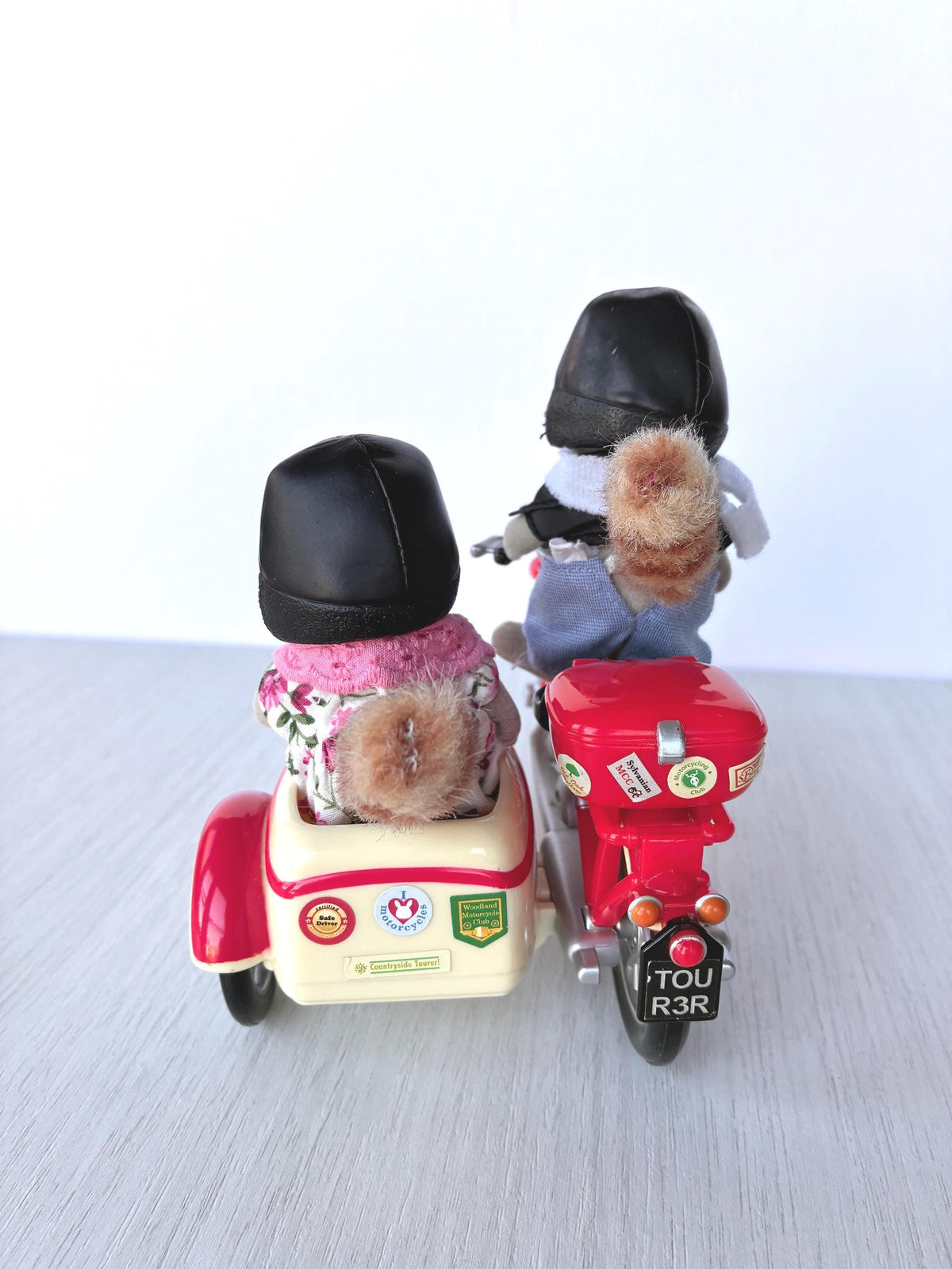Calico Critters Sylvanian Families raccoon grandparents riding the Motorcycle and Sidecar seen from behind, sticker-covered sidecar and TOUR 3R rear plate