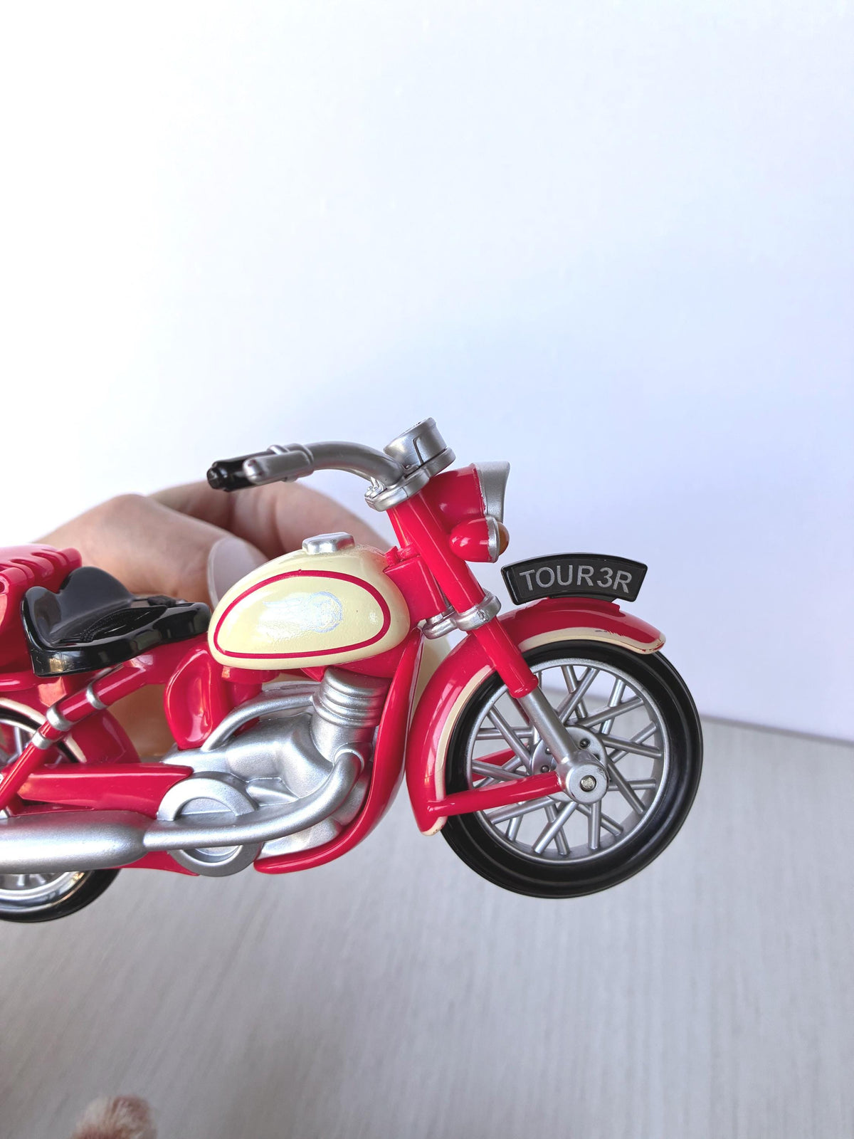 Calico Critters Sylvanian Families Motorcycle close-up of cream fuel tank, silver forks, spoked front wheel and TOUR 3R number plate